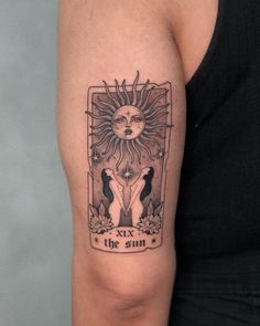 a woman with a tattoo on her arm has a sun and two birds in the background