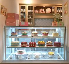 a display case filled with lots of cakes