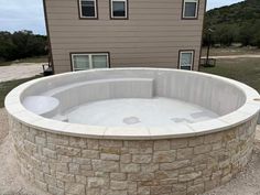 an outdoor hot tub in front of a house