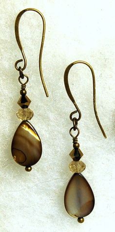 Taupe shell, brown Swarovski crystal and Cognac quartz are featured in these classic simple pierced earrings. All metal is brass and is light weight. Each earring weighs 1.2 grams as compared to a US dime weighing 2.268 grams, so light weight. Size and length can be determined in the photo above as compared to a US dime and a ruler. If you are interested in these earrings and would like more photos or have any questions please feel free to contact me. I usually answer all inquiries the same day Brown Earrings, Wire Wrapped Necklace, Shell Beads, Quartz Pendant, Pierced Earrings, Earings Piercings, Swarovski Crystal, Lovely Gift, Ruler