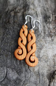 "These beautiful and unique hand-carved Celtic knot earrings will be made for you, or a loved one, in my studio on the West of Ireland. Adorned with Sterling silver inlays, these long Celtic earrings feature pieces of Irish Yew wood. Considered one of the Sacred trees in the Celtic world, the Yew has long been associated with immortality & longevity. As a consequence, warriors and poets alike were often called after it. Indeed, Eoghan remains one of the more popular Irish names in modern Ire Traditional Spiral Jewelry For Gifts, Artisan Plug Earrings As A Gift, Spiral Pierced Earrings As Gift, Spiral Pierced Earrings For Gift, Unique Engraved Earrings As A Gift, Unique Engraved Earrings For Gift, Engraved Earrings For Gifts, Handmade Symbolic Plug Earrings As Gift, Irish Yew