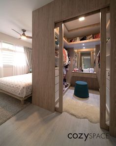 an open closet in a bedroom next to a bed