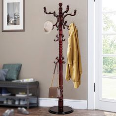 a coat rack with two coats hanging on it