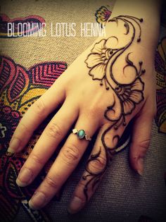 a woman's hand with henna on it and the words, blooming lotus hen