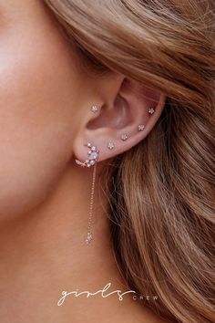 a woman wearing a pair of ear piercings