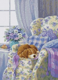 a cross stitch picture of a dog sleeping on a chair in front of a window