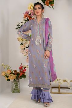 Divine into regal perfection with regal lilac blue. This lilac blue marvel boasts a neckline adorned with vibrant resham, beads and sparkle of sitara, delicately enhanced with beautifully curated bunch on neck line, sleeves and back as well, floral motifs on all over shirt front and intricate resham embroidey and lace work on shirts hem.to complete this ethereal ensemble it is paired with ombre dyed dupatta and two tier ruffled trouser. Shirt Fabric: Pure jacquard maysuri Shirt Length: 48” Pant Designer Embroidered Neckline Dress For Diwali, Festive Anarkali Dupatta With Embroidered Neckline, Festive Dupatta With Embroidered Neckline For Eid, Eid Festive Dupatta With Embroidered Neckline, Elegant Embroidered Salwar Kameez, Bollywood Style Kurta With Embroidered Neckline For Diwali, Festive Wedding Dupatta With Embroidered Neckline, Festive Embroidered Neckline Wedding Dupatta, Elegant Designer Salwar Kameez With Embroidered Neckline