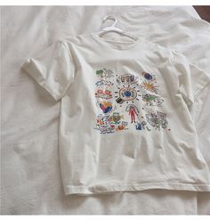 Name: color graffiti, white large size top, loose tide T-shirt short sleeve topMaterial:cottonColor:whiteFeatures:color graffitiSize(cm) :M,L,XL,2XL 1inch=2.54cmM:shoulder:46,bust:94,sleeve:20,length:60,Recommended weight:42kg-49kgL:shoulder:48,bust:98,sleeve:21,length:62,Recommended weight:50kg-56kg&ltp&gtXL:shoulder:50,bust:102,sleeve:22,length:64,Recommended weight:561kg-62kg</p>&ltbr/>&ltp&gt2XL:shoulder:52,bust:106,sleeve:23,length:66,Recommended weight:62kg-69k Artistic White Top With Screen Print, Artsy White Graphic T-shirt, Artsy White Crew Neck T-shirt, Artistic White Summer T-shirt, White T-shirt With Cartoon Print For Spring, White Casual T-shirt With Cartoon Print, Casual White T-shirt With Cartoon Print, Artistic White Cotton T-shirt, Artsy White Short Sleeve T-shirt