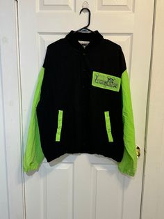 Laguana neon green and black Nylon windbreaker, jacket. 7 black snap front closure, lauguana on front with palm tree font, two front pockets lined in neon green 100% nylon XL Measures 26" shoulders, 27" chest, 22" stretch waist, 25" sleeve, 22" inseam. Skater jacket, warm up, surfer, beach wear, 1990s fashion Skater Jacket, Neon Green Cyberpunk Outfit, Neon Windbreaker, Green Windbreaker With Double-lined Hood For Streetwear, Neon Green Jacket, Neon Green Alternative Outfit, Green Vest, 1990s Fashion, Beach Wears