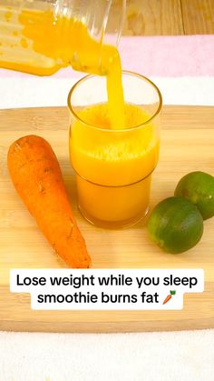 a person pouring orange juice into a glass next to a carrot on a cutting board