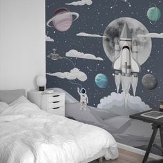 a bedroom with a space theme painted on the wall