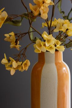 two vases filled with yellow and white flowers