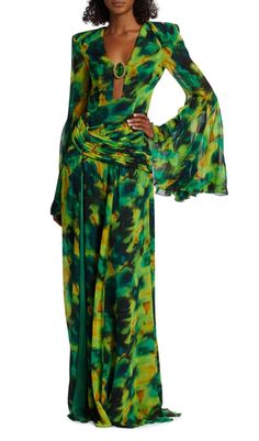 Printed chiffon maxi dress flows elegantly in a bright pattern, centered with stone detail at the plunging neck. Framed by sweeping bell sleeves, this look wraps at the waist with pleats and features a backless design. Plunge neck with gemstone Long sleeves Flared cuffs Back zip closure Button closure at nape Dry clean Colour may vary due to lighting on images. The product images (without model) are closest to the true colour of the product.Item runs true to size chart and is cut to suit our siz Print Chiffon Maxi Dress, Flare Sleeve Dress, Printed Gowns, Printed Summer Dresses, Plunging Neck, Long Sleeve Print Dress, Charm Making, Chiffon Maxi, Green Diamond