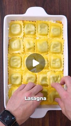 someone is placing ravioli on top of the lasagna in a baking dish