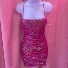 Pink Glitter Dress For Night Out Made With 100% Polyester, Has Glitter Accents All Around Glitter Mini Dress For Prom, Pink Sequined Disco Dress, Summer Party Lurex Dress, Summer Party Mini Dress In Lurex, Summer Party Dress In Lurex, Party-ready Fitted Mini Dress With Glitter, Glitter Mini Dress For Prom And Holiday, Pink Sequin Mini Length Fabric For Party, Pink Disco Evening Dress