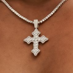 Introducing the Iced Gothic Cross in White Gold - a stunning addition to your pendant collection. Crafted with a durable 14k White Gold finish and hand-set stones, this cross is guaranteed to make a statement! Pair this piece with our 3mm Tennis Necklace in White Gold for a complete, elevated look. This product is guaranteed for life - GLD will repair the item should you experience any defects in craftsmanship or breakage. Specifications - 35mm x 42mm (Width x Height) - Bail: Fits up to 5mm Tenn Iced Cross Necklace, White Gold Cross Jewelry For Spiritual Style, Iced Out White Gold Cross Pendant Jewelry, Spiritual White Gold Cross Jewelry, Iced Out Diamond Cross Jewelry, Silver Iced Out Cross Pendant Necklace, Luxury Cubic Zirconia Cross Jewelry, Iced Out Diamond Cross Pendant Jewelry, Diamond Cross Necklace Iced Out