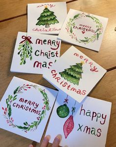 four christmas cards with watercolor designs on them