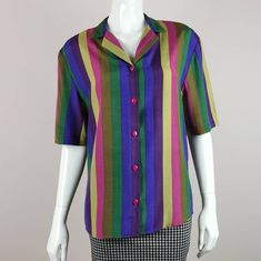 80s vintage vibrant bold striped shirt. Details: *Relaxed fit with notched collar and short sleeves. *Button down front. *Mixed colour wide stripe print. *Viscose material. *Excellent condition. Size estimate: m UK: 12 US: 10 EU: 40 Measurements: bust: 40in length: 27in Thank you for looking and please let me know if you have any questions - I am always happy and quick to help ⭐ ❤️ Click the heart button and add our shop to your favourites, so you can be alerted to new listings, sales and coupons! ❤️ Remember your special code (5OFFMYFAVE) for £5 discount at checkout ^-^ *browse Etsy shop here* www.etsy.com/uk/shop/AgeOfVintageUK p.s discover what our customers are saying by checking out our reviews :)  S/M Multicolor Short Sleeve Tops With Striped Collar, Multicolor Short Sleeve Top With Striped Collar, Retro Multicolor Short Sleeve Shirt For Spring, Retro Multicolor Button-up Shirt, Retro Short Sleeve Purple Shirt, Retro Multicolor Short Sleeve Shirt, Multicolor Retro Short Sleeve Shirt, Retro Purple Short Sleeve Shirt, Multicolor Vertical Stripes Shirt For Summer