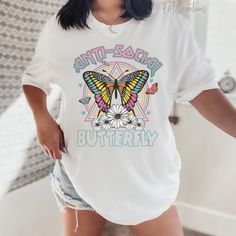 "You will love this really cute Bella Canvas 3001 soft tshirt that has bright colors and reads \"Antisocial Butterfly\". This tshirt is perfect for either yourself or that antisocial that hates being around people. This is the perfect gift idea for your gf, bestie, mom, etc. I can assure you that introvert will love this really cute butterfly tshirt! *Please note that the colors/design may vary depending on the screen being viewed on! *Tshirt Specs- Bella Canva 3001 unisex tshirt: *UNISEX SIZE G Cute Butterfly Print Crew Neck T-shirt, Cute Butterfly Print T-shirt For Spring, White Butterfly T-shirt For Spring, Cute Short Sleeve T-shirt With Butterfly Print, Cute Butterfly Print Short Sleeve T-shirt, White Butterfly T-shirt For Summer, Trendy White T-shirt With Butterfly Print, Summer Cotton T-shirt With Butterfly Sleeves, Multicolor Casual T-shirt With Butterfly Print