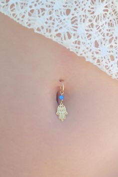 "A feminine and delicate Hamsa belly button ring made with a unique blue opal stone. This navel piercing is handmade of a 14k gold filled or Sterling Silver hoop and a Hamsa hand pendant. The Hamsa (or Hand of Fatima) is a middle-eastern symbol of good luck, to keep evil spirits away. Wear it or give it to a loved one to use as an amulet to give protection and good luck. Do not hesitate to contact me for special requests and customization! ♥♥ ▶ 14K Goldfilled or Silver wire 1.2 mm (16 gauge) wid Dangle Belly Rings For Wedding, Bohemian Belly Rings As A Gift, Delicate Body Jewelry As Gift, Sterling Silver Belly Rings As Gift, Adjustable Pierced Belly Rings As Gift, Dainty Internally Threaded Belly Rings As Gift, Dainty Nickel-free Belly Rings As Gift, Dainty Dangle Belly Rings As Gift, Dainty Hypoallergenic Belly Rings