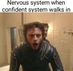 a man with his mouth wide open standing in front of a mirror that says, nervous system when the confident system walks in