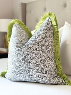 two pillows on top of a white bed