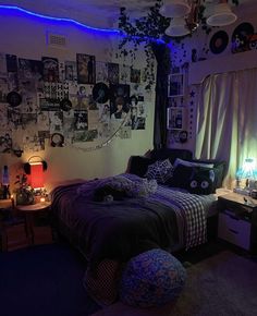 a bed room with a neatly made bed and lots of pictures on the wall above it