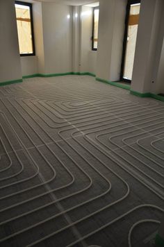 an empty room with multiple heating lines on the floor