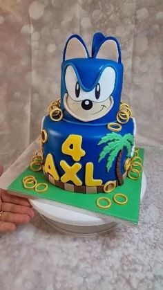 a birthday cake with a sonic the hedgehog theme on top and palm trees around it