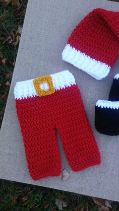 crocheted santa pants, hat and booties are laying on the ground