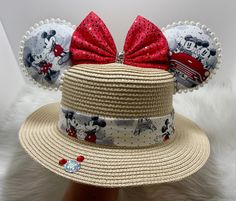 a straw hat with minnie mouse ears on it