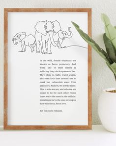 an elephant poem is shown in a frame next to a potted plant and a white wall