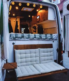 the back end of a van with a couch in it