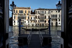 a boat that is sitting in the water next to some buildings with windows on each side