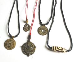 These pendants symbolize for healing and protections. They are old and used for health, wealth and protections from everything. Made out of bronze most of them. (1) Tibetan dzi design pendant (2) Mandala for protect from four directions pendant (3) Good luck and Fortune pendant (4) Feng shui for good luck and power. This pendant has design on both sides. feng shui symbols for good luck and dragon for power. (5) Ganesh in the Om letter. Protections, health and wealth. Traditional Medallion Necklace For Good Luck, Traditional Good Luck Medallion Necklace, Bronze Spiritual Jewelry For Good Luck, Amulet Style Long Necklace For Meditation, Symbolic Bronze Necklace For Meditation, Blessing Amulet Necklace With Coin Pendant, Bronze Amulet Necklace For Rituals, Bronze Amulet Necklace For Blessing, Bronze Good Luck Amulet Necklace