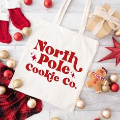 the north pole cookie co tote bag surrounded by christmas decorations