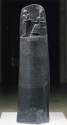 an ancient egyptian statue is shown in black and white, with the image of two people sitting