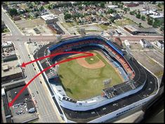 an aerial view of a baseball field with red arrows pointing to the left and right