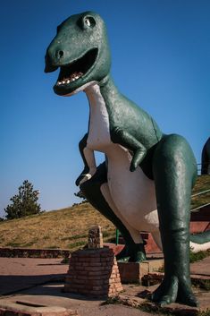 a statue of a dinosaur with its mouth open