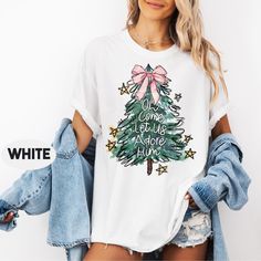 Comfort Colors Oh Come Let Us Adore Him T-Shirt, Jesus Christmas T Shirt, Coquette Christmas Tree Shirt,  Christian Christmas Shirt ### Product Details -Our t-shirts come from the Comfort Colors brand. -These unisex shirts are made with 100% ring-spun cotton, ensuring a soft and relaxed feel. ### Size Guide - Refer to our detailed size chart, complete with images, to find your perfect fit. -If you prefer a looser fit, we recommend selecting a size that's two sizes bigger than your regular one. ### Ordering Instructions 1. Examine the product images and size charts for detailed information. 2. Choose your desired color. 3. Select your appropriate size. 4. Click "ADD TO CART" and include any additional items you may want. 5. Proceed to checkout when you are ready. ### Shipping and Processing Cute White Christmas T-shirt, Come Let Us Adore Him, Shirt Coquette, Coquette Christmas, Jesus Christmas, Christmas Tree Shirt, Christmas Jesus, Tree Shirt, Christian Christmas