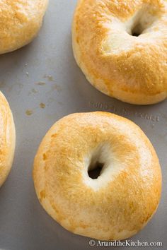 four bagels sitting on top of a baking pan