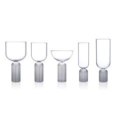 four wine goblets are lined up in a row