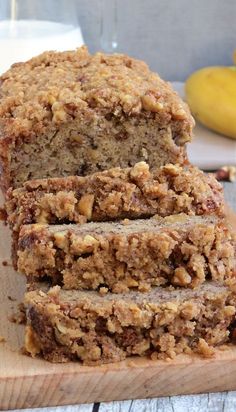 sliced loaf of banana bread sitting on top of a wooden cutting board