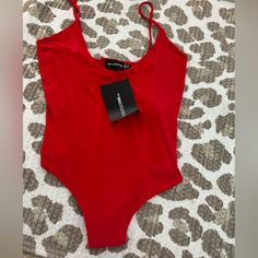 Silky Red Bodysuit With Spaghetti Straps. The Straps Are Not Adjustable Red Fitted Swimwear With Spaghetti Straps, Red Spaghetti Straps Swimwear For Summer, Trendy Red Stretch Bodysuit, Red Sleeveless Bodysuit For Summer, Chic Red Bodysuit For Summer, Trendy Red Sleeveless Swimwear, Red Lined Bodysuit For Spring, Trendy Red Bodysuit For Beach, Red Summer Party Bodysuit