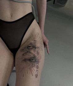 a woman's thigh with tattoos on it