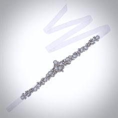 Add a touch of classic elegance to your bridal gown with this sparkling beaded belt! Adorned with an array of glowing Swarovski opals and crystals on a silver base, it will give your dress an extra touch of glam to finish off your perfect look on your wedding day. The crystal appliqué measures approx. 14" (approx. 35.5cm) long by 2" (approx. 5cm) at the widest point. It can be ordered attached to your choice of white organza ribbon, white or ivory double-faced satin ribbon, 0.75" (approx. 2cm) w White Crystal Bridal Belt With Rhinestones, Formal Crystal Bridal Belt With Sashes, Elegant Crystal Bridal Belt With Sashes, Fitted Crystal Bridal Belt Embellished, Adjustable Silver Crystal Bridal Belt, Bridal Sash Belt, Beaded Belt, Sash Belts, Bridal Sash