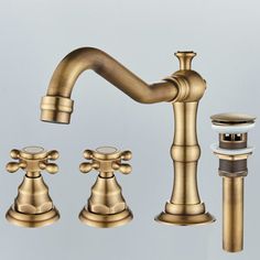 a faucet with two handles and three soap dispensers