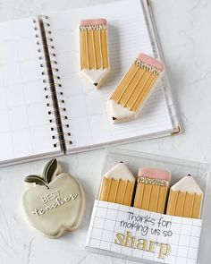 some cookies that have been made to look like pencils in the shape of an apple