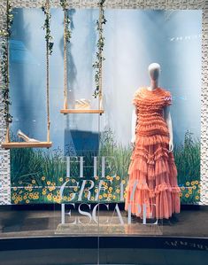 an orange dress on display in front of a window