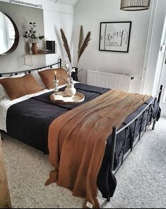 a bedroom with a bed, mirror and other items on the table in front of it